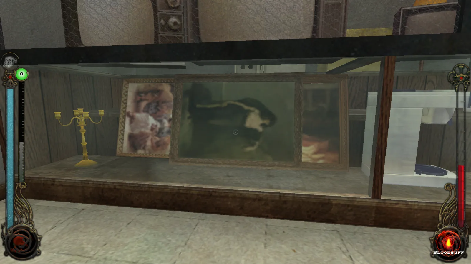L'image est une capture d'écran du jeu Vampire: The Masquerade – Bloodlines. La caméra, qui adopte le point de vue du personnage joueur, nous montre la vitrine d'un prêteur sur gage. Cette vitrine renferme plusieurs objets, dont un mixeur et un candélabre, ainsi que trois tableaux, dont le premier, couché sur le côté, est une oeuvre du peintre Charles Mengin.