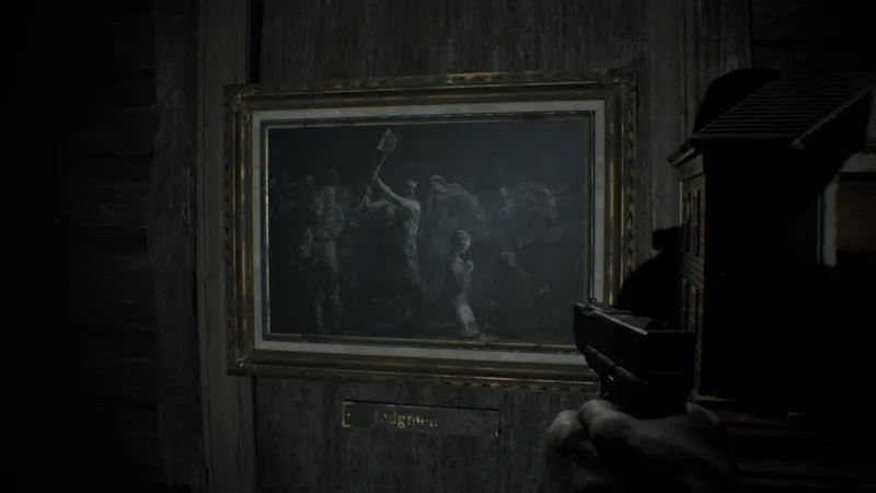 L'image est une capture d'écran du jeu Resident Evil 7. La caméra, qui adopte le point de vue du personnage joueur, nous montre un mur auquel est accrochée une peinture en grisaille représentant l'exécution d'une jeune femme. Elle se tient à genoux au centre de la représentation, tournée vers la droite. Derrière elle, un bourreau lève sa hache. Tout autour de nombreux personnages assistent à la scène.